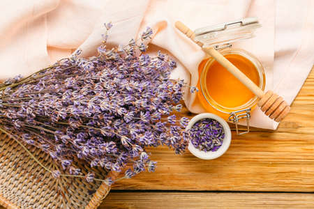 Composition with lavender flowers and honey on wooden background, closeupの写真素材