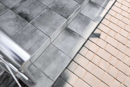 View of granite steps and pavement outdoors