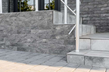 View of granite stairs with banister outdoors