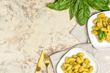Plates with tasty pesto gnocchi on light backgroundの写真素材