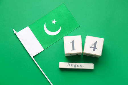 Flag of Pakistan and calendar with date of Independence Day on color backgroundの写真素材