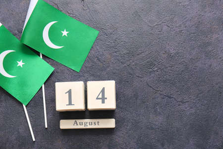 Flags of Pakistan and calendar with date of Independence Day on dark backgroundの写真素材