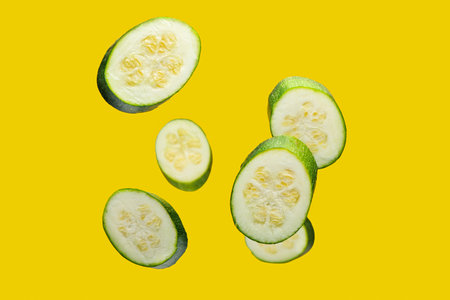 Flying squash slices on color backgroundの写真素材