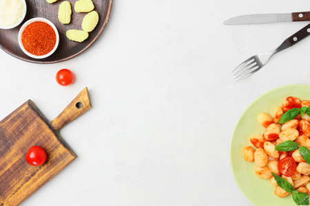 Tasty gnocchi on light background