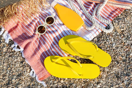 Set of beach accessories on sand, closeup
