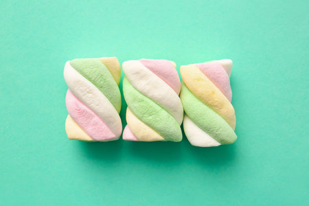 Tasty marshmallows on color background