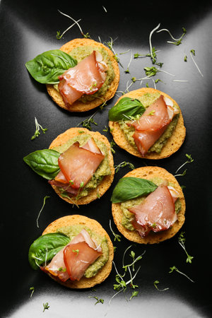 Tasty sandwiches with guacamole and ham in plate, closeupの写真素材