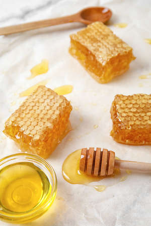 Bowl of honey and combs on tableの写真素材