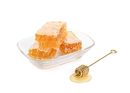 Bowl of honey combs on white backgroundの写真素材