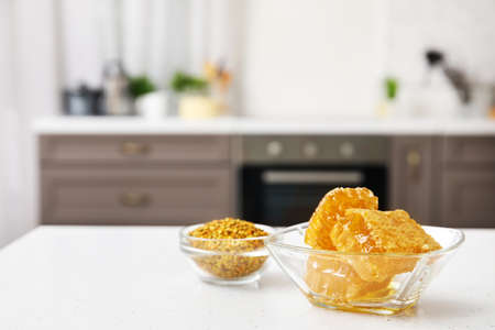 Bowl of honey combs on table in kitchenの写真素材
