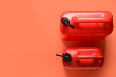 Plastic jerry cans on color background