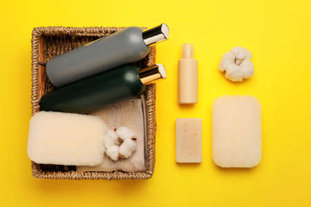 Bath supplies with sponges on color background