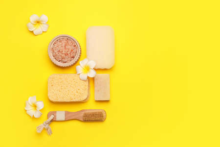 Bath supplies with sponges on color background