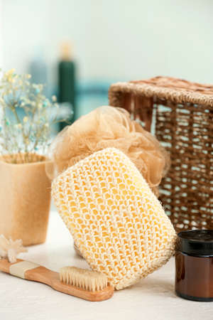 Bath sponges and supplies on table in bathroom, closeup