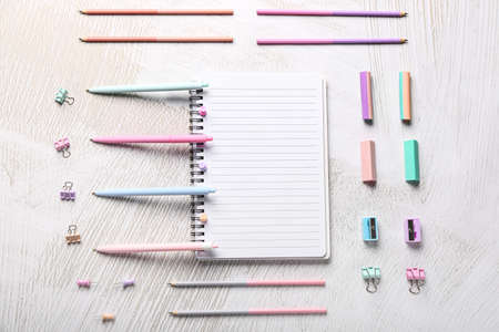 Stationery supplies on white wooden background