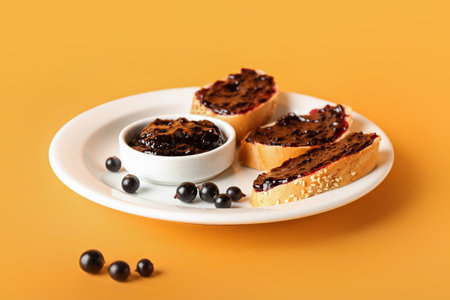 Toasts with black currant jam on color backgroundの写真素材