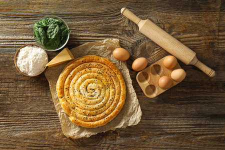 Composition with tasty spinach pie on wooden backgroundの写真素材