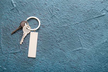 Keys with stylish keychain on dark backgroundの写真素材