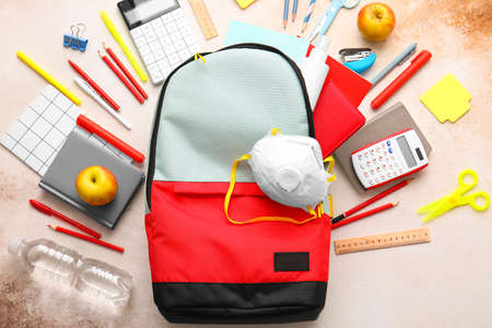 School backpack and stationery on light backgroundの写真素材