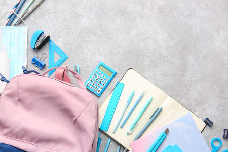 School backpack and stationery on light backgroundの写真素材