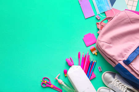 School backpack and stationery on color backgroundの写真素材