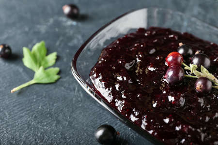 Bowl with black currant jam on dark backgroundの写真素材