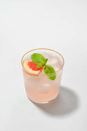 Glass of tasty grapefruit margarita on white backgroundの写真素材