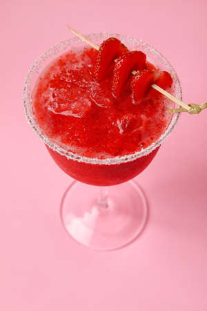 Glass of tasty strawberry margarita on color backgroundの写真素材