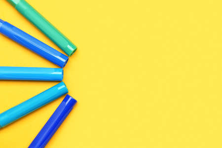 Colorful markers on color background