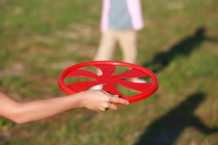 Cute little children playing disk outdoors