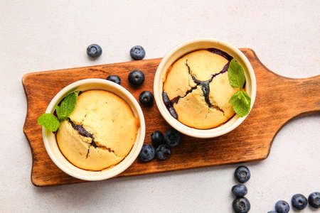 Ramekins with blueberry cobbler on light backgroundの写真素材