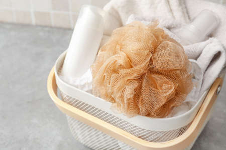 Basket with soft sponge, white towel and cosmetic productsの写真素材