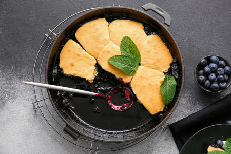 Frying pan with blueberry cobbler on gray backgroundの写真素材