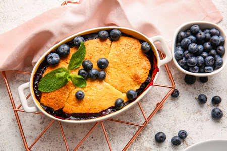Baking dish with blueberry cobbler on light backgroundの写真素材