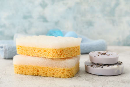 Lavender soap and bath sponges on table