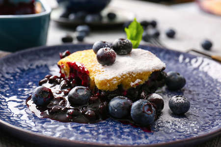 Plate with piece of blueberry cobbler on table, closeupの写真素材
