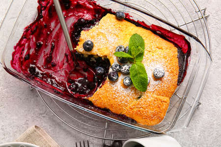 Baking dish with blueberry cobbler on light backgroundの写真素材