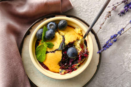 Ramekin with blueberry cobbler on light background, closeup
