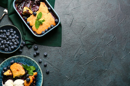 Composition with blueberry cobbler and ice cream on dark backgroundの写真素材