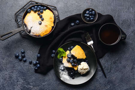 Composition with blueberry cobbler and ice cream on dark backgroundの写真素材
