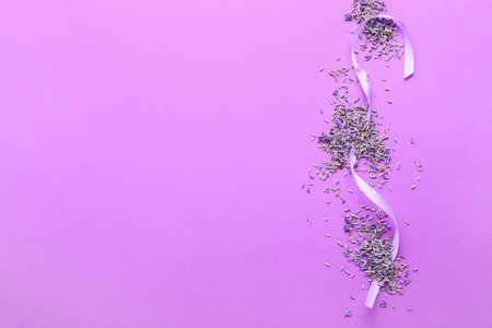 Composition with lavender flowers and ribbon on color backgroundの写真素材