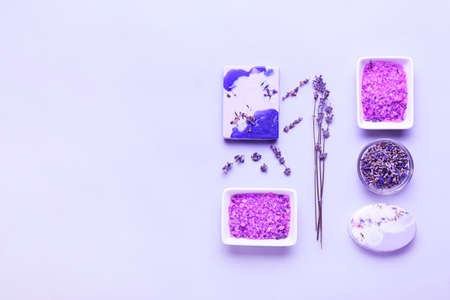 Composition with sea salt, soap bars and lavender flowers on white background