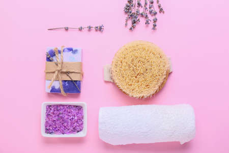Composition with bath supplies and lavender flowers on color background