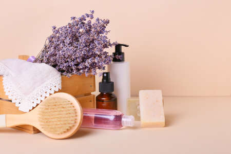 Composition with bath supplies and lavender flowers on color backgroundの写真素材