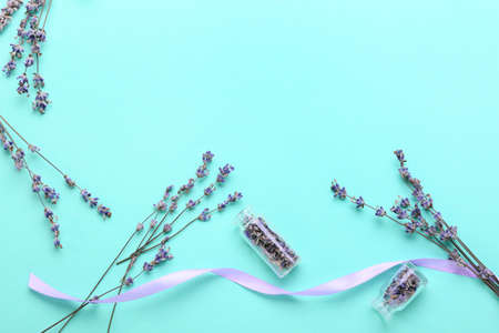 Composition with beautiful lavender flowers on color background
