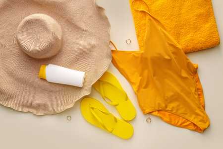 Set of beach accessories on color background
