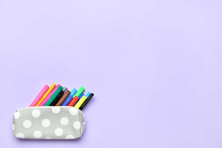 Pencil case with colorful markers on color backgroundの写真素材