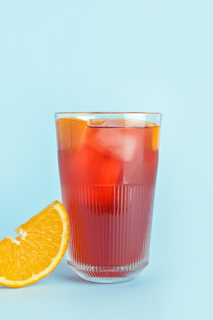 Glass of tasty Negroni cocktail on color backgroundの写真素材