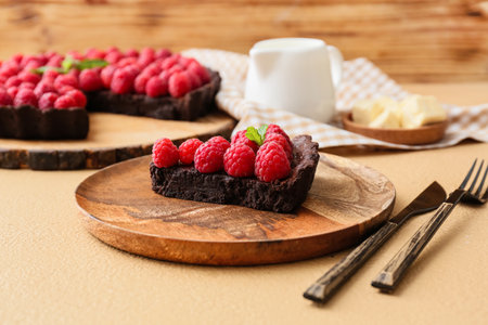 Plate with piece of tasty raspberry pie on color table, closeupの写真素材