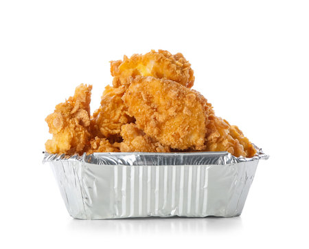 Foil container with tasty popcorn chicken on white backgroundの写真素材